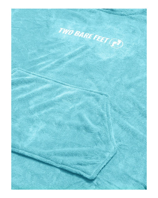 Close-up image of light blue towel poncho fabric