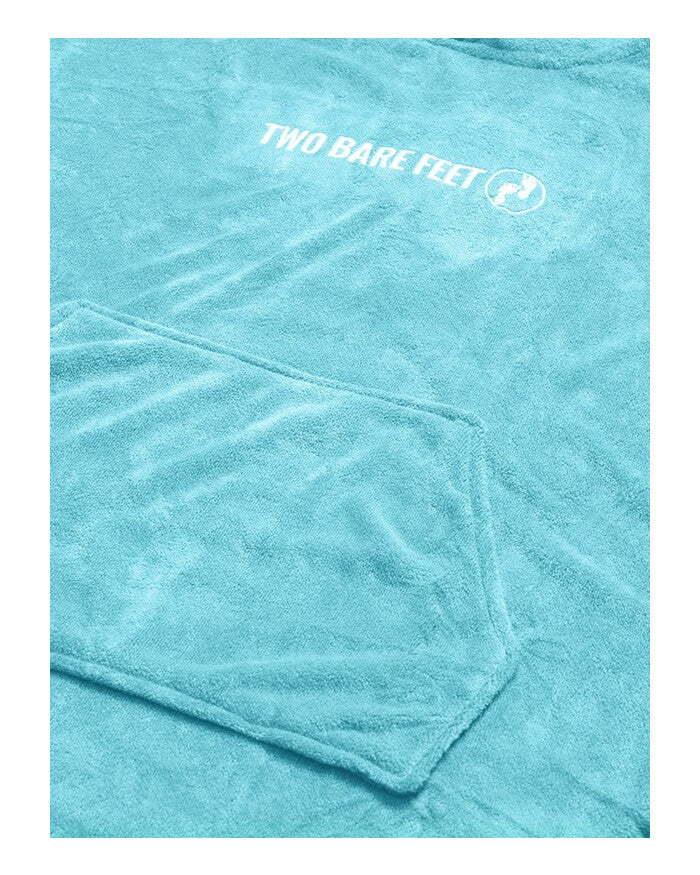 Close-up image of light blue towel poncho fabric